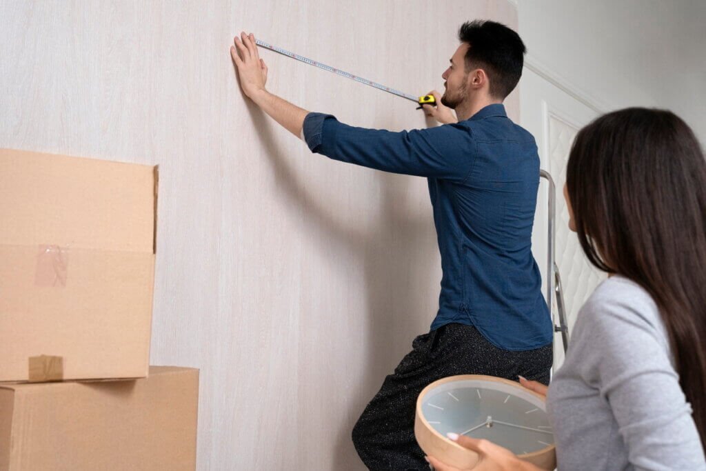 couple measure a living room